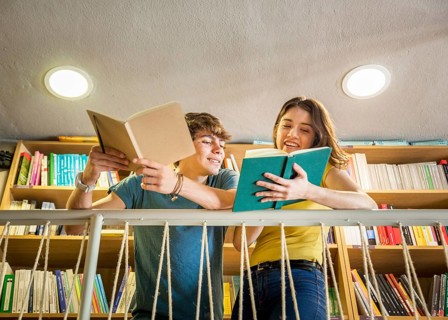 Teen girl showing book boyfriend