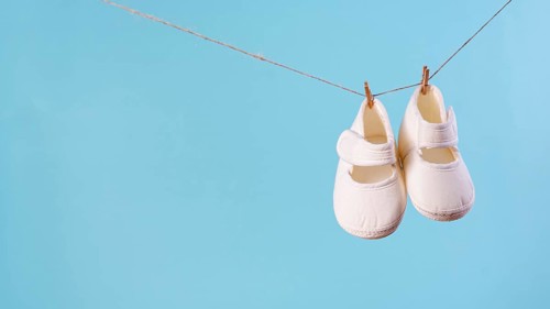 Front view cute little baby shoes with copy space