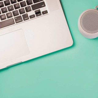 Close up bluetooth speaker laptop green background