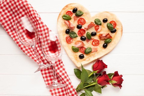 Top view heart shaped pizza with wine