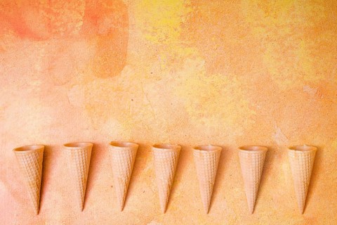 Waffle cones row multicolored background