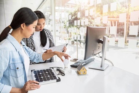 Asian women working hard together indoors