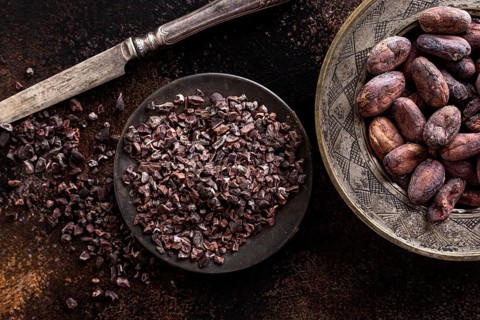 Top view grounded cocoa beans plate with knife cocoa beans