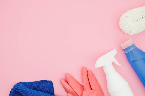 Cleaning supplies pink background