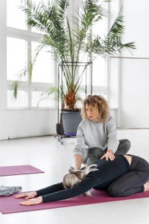 Full shot woman stretching with teacher