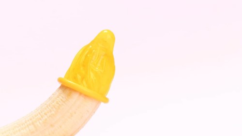 Yellow unwrapped condom banana