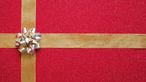 Silver bow golden ribbons red background