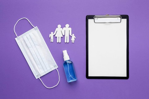 Top view family made paper with clipboard medical mask