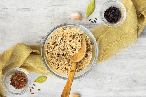 Different rice types bowls with spoon table