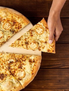 Flat lay hand taking slice pizza with cheese