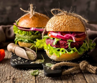 Front view vegetarian burgers cutting board
