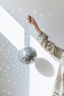 New year party concept with girl holding disco ball