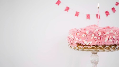 Pink cake decorated with candle