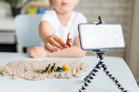 Close up kid holding dinosaur