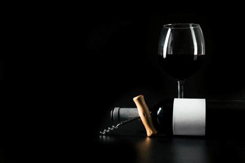 Corkscrew bottle near wineglass