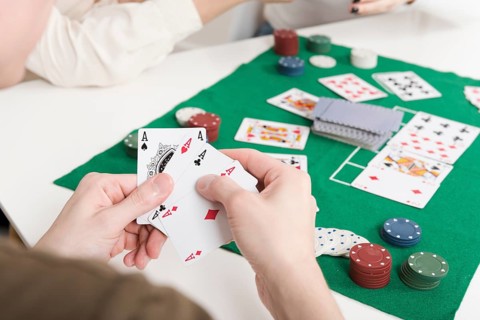 Close up person playing poker