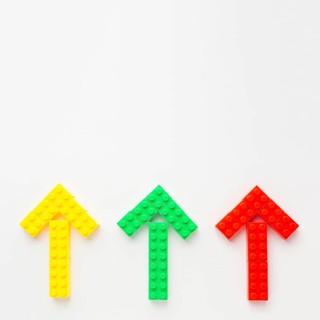 Top view colored toy arrows pointing up