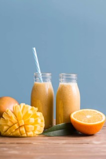 Front view smoothie bottles with mango orange