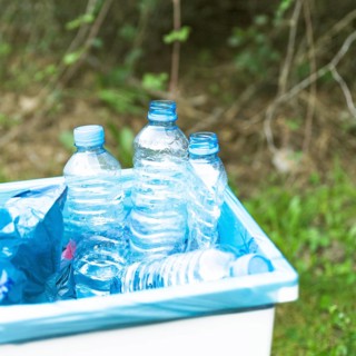 Trashcan with plastic garbage outdoors