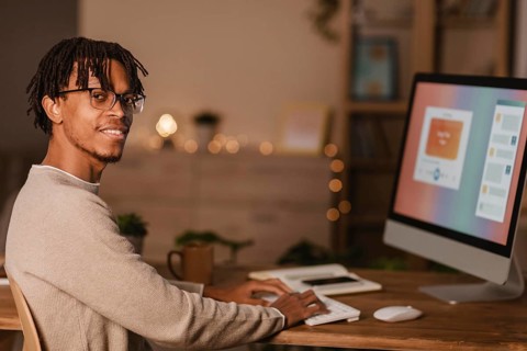 Side view man using personal computer home