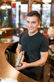 Smiling man with cocktail shaker