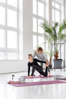Woman practice yoga with teacher