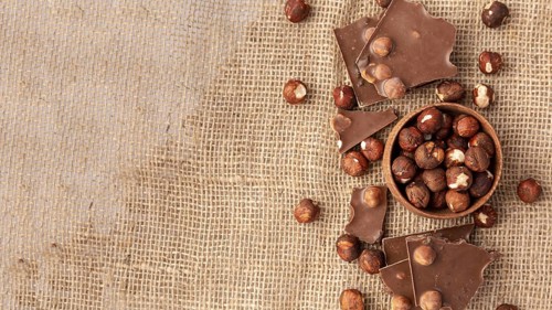 Top view chocolate with hazelnuts burlap copy space