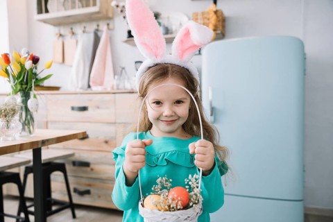 Girl bunny ears holding basket with easter eggs
