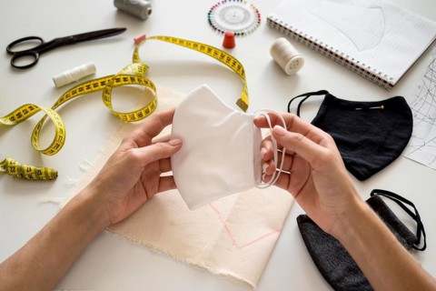 Woman holding face mask she sew