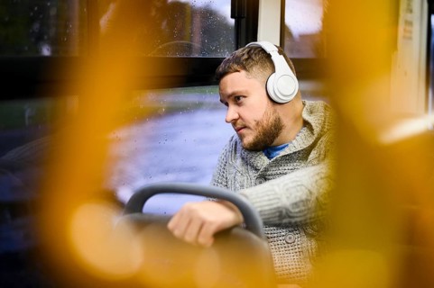 Man with headphones traveling by bus
