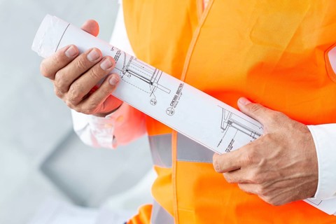 Architect holding plans close up