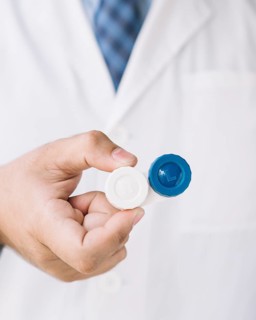Doctor with holding pair contact lenses