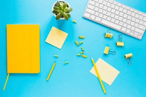 Bright desktop with computer keyboard diary