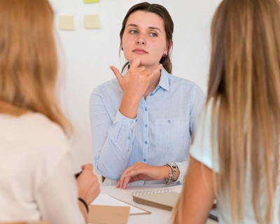 Woman teaching sign language other people