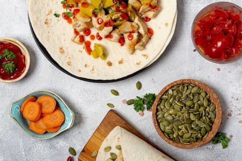 Mexican food burrito near vegetables cardamom seeds