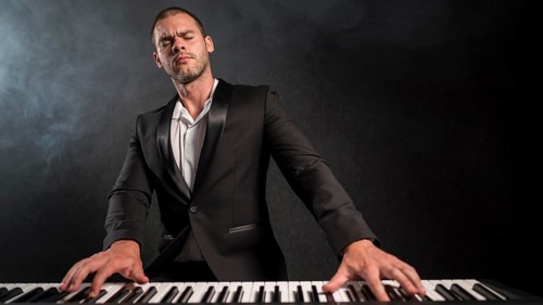 Front view passionate musician playing digital piano