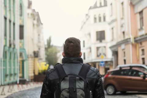 Man with backpack old street