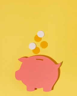 Top view piggy bank yellow background