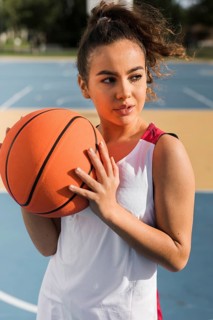 Front view girl holding basketball ball