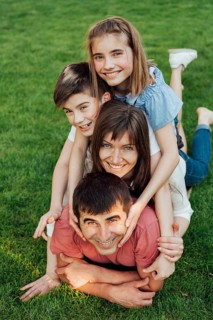 Portrait happy family laying grass park