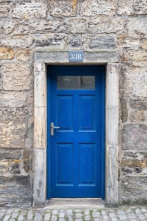 Blue front door on an old stone house