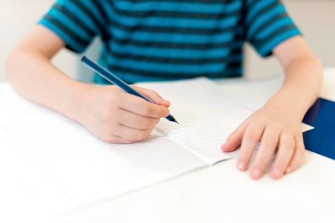 Kid writing empty notebook