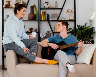 People with guitar couch