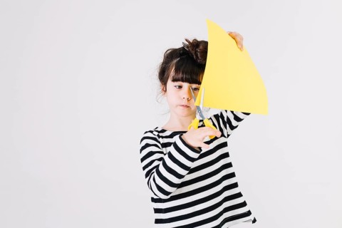 Sweet girl cutting paper