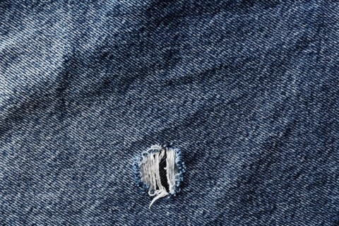 Coarse denim surface with tear