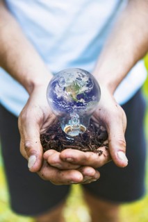 Concept hands holding earth bulb