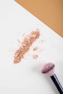 Overhead view face powder brush dual colored background