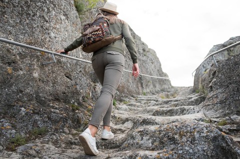 Back view traveller climbing stairs