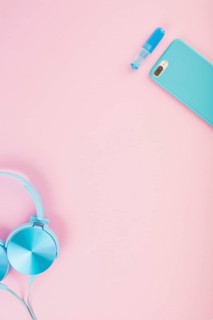 Elevated view headphone smartphone pink background