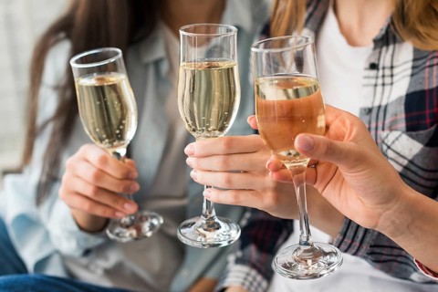 Women holding champagne glasses toast